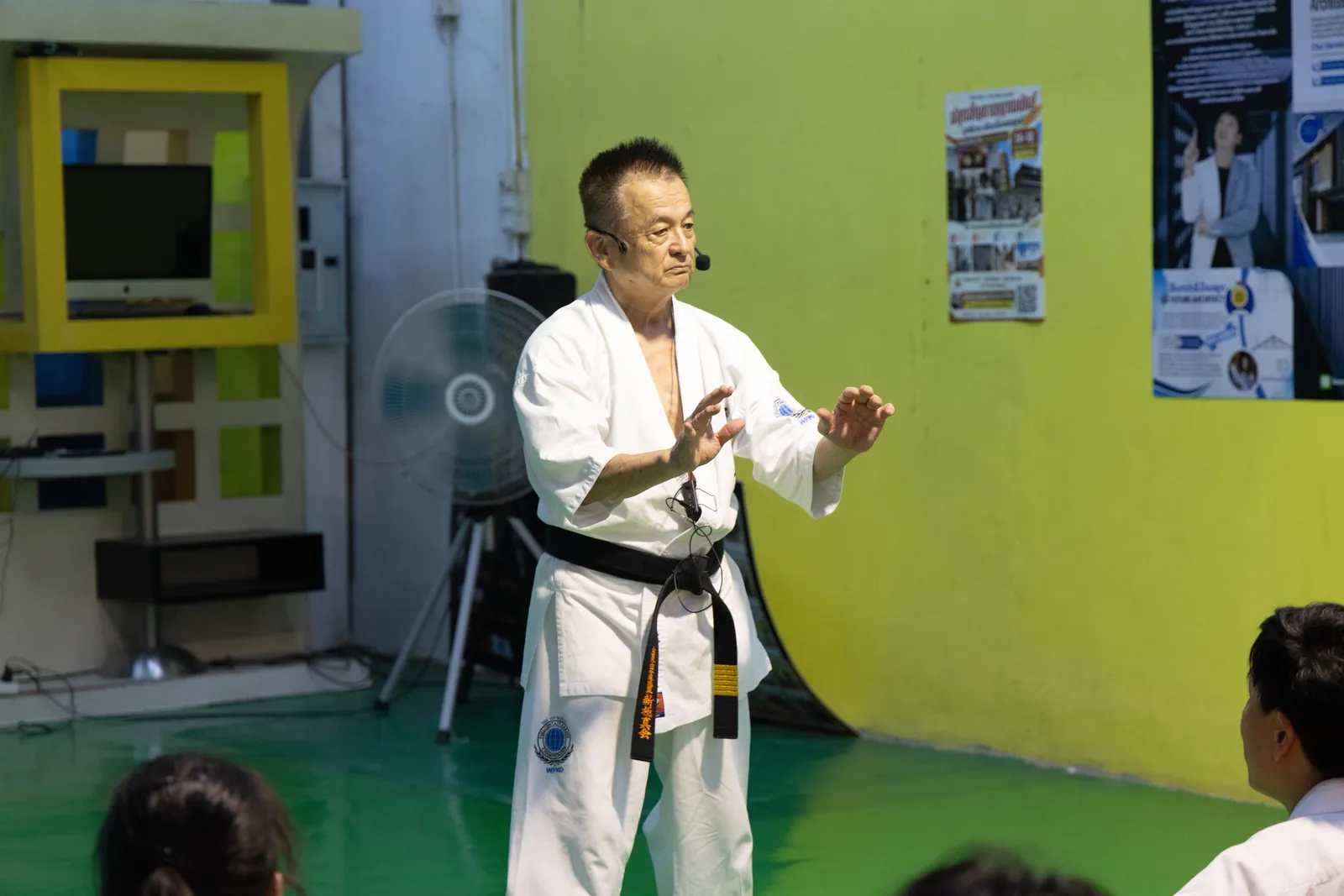 Shihan Nagashima ยืนยกมือทั้งสองข้างระดับหน้าท้อง อธิบายการควบคุมตันเถียน