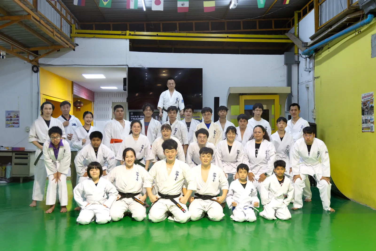นักเรียนและครูทั้งคลาสถ่ายภาพหมู่กับ Shihan Nagashima ตรงกลาง มีทั้งเด็กและผู้ใหญ่